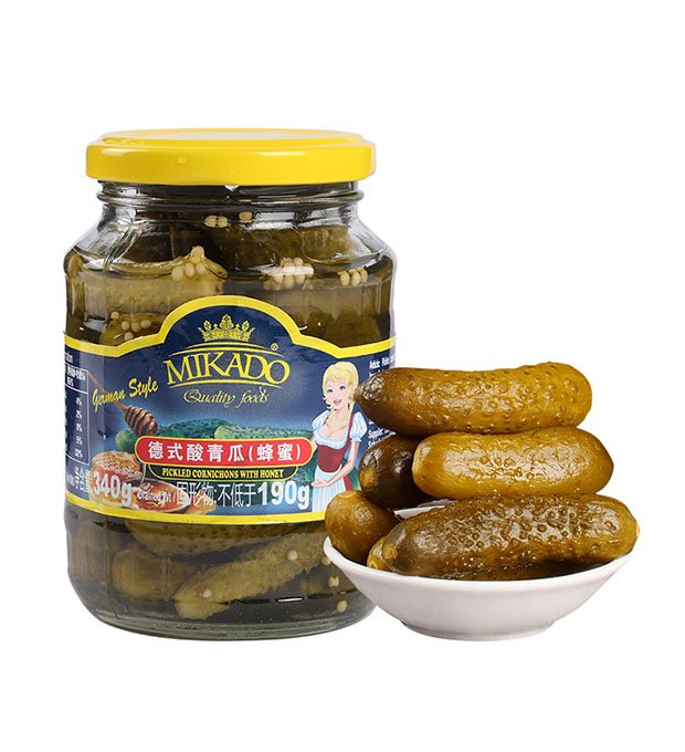 pickled gherkins in brine glass jars