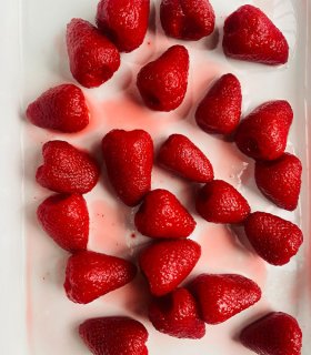 close-up of red canned strawberries in glossy syrup